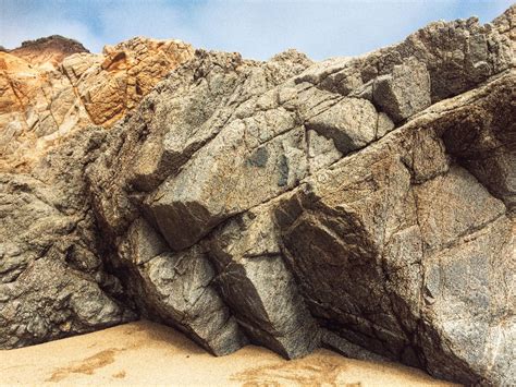 What causes these holes in large rocks on beaches? : r/geology