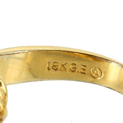 What does 18k g e mean. Rolled Gold Hallmarks. Gold jewelry should always come with a stamp that indicates its level of purity and how much gold has been used. The letters RG is used to specify that the metal is rolled gold. You will also come across RGP for Rolled Gold Plate. If your piece of gold jewelry has a mark such as 1/20 18K RG this indicates that the item is ... 