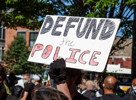 What does defund the police mean. Riot police outside St. John’s Church in Washington D.C. after the area was cleared of people protesting the death of George Floyd, 2020. (Photo by Brendan Smialowski / AFP via Getty Images) 