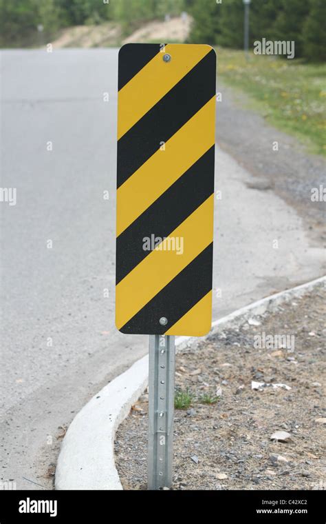 What does the black and yellow striped road sign mean?