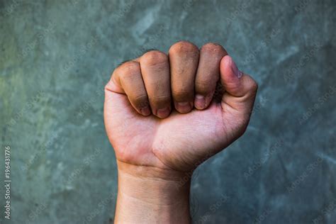 What does the symbol of a raised clenched fist mean?