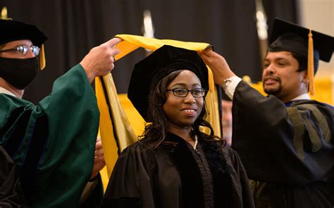 Your faculty mentor will hood you as a doctoral candidate. If you do not have a mentor present, a Commencement marshal will hood you. See more.