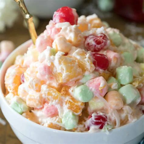 What is ambrosia. Mix the ingredients. In a large bowl, mix together crushed pineapple, mandarin oranges, Cool Whip, sour cream, marshmallows, and shredded coconut. Cover the bowl with plastic wrap. Chill. Refrigerate the salad for at least two hours to give the fruit flavors ample time to blend. 