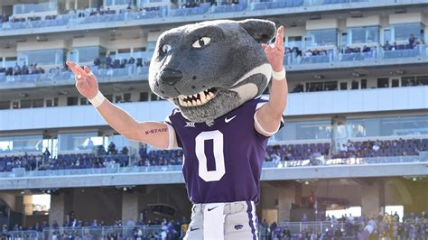 Kansas State mascot Willie the Wildcat leads the team on the