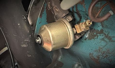 What is the sensor located next to the oil sending unit on top of block