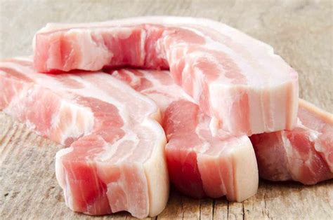 Where can you buy pork belly. Instructions. Place the pork belly pieces, skin side down on a work surface and then make 1 ½ inch crosswise cuts on each piece, being careful not to cut through the skin. Rub the pork belly strips with baking powder and baking soda and place in a medium saucepan. Add the water and salt. 