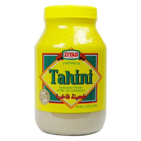 Where to buy tahini. Preheat oven to 350 degrees F (176 C), and arrange sesame seeds on a bare baking sheet. Bake for 10 minutes, or until slightly golden brown (being careful not to burn). Remove from oven and let cool for 5 minutes. Then add to a food processor and blend until smooth, adding avocado or olive oil to encourage blending. 
