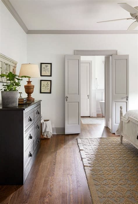 White walls grey trim. Neutral paint color doesn't always mean beige or taupe. A muted blue or green can feel every bit as neutral as a warm color. Valspar Distant Valley is a soothing blue-gray paint color that pairs well with warm neutrals, and creamy white wall trim. Charcoal gray furniture and accessories would be stunning with this color. 
