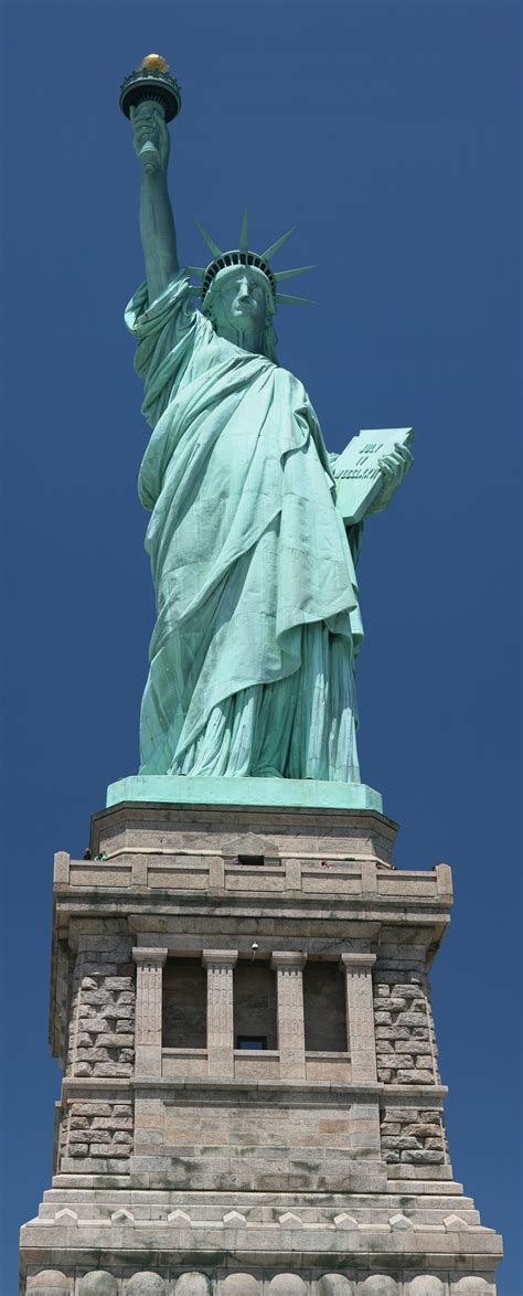 Who made the statue of liberty. The Editors of Encyclopaedia Britannica. The Statue of Liberty is a 305-foot (93-metre) statue located on Liberty Island in Upper New York Bay, off the coast of New York City. The statue is a personification of liberty in the form of a woman. She holds a torch in her raised right hand and clutches a tablet in her left. 