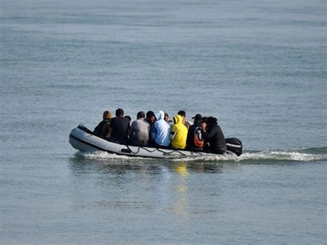 Why are migrants in small boats a heated issue in the UK?