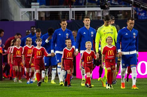 Why do soccer players walk out with kids. Have you ever wondered why soccer players walk onto the field with kids? The answer might surprise you. The 1999 FA Cup Final was the first game where kids walked out with players, having just one ... 