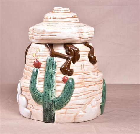 Wile e coyote cookie jar. This Wile E coyote cookie jar is in mint condition. It is a retired cookie jar and was issued by Certified International in the late 1980s. This jar depicts Wile E Coyote on an Acme Rocket and I'm sur 