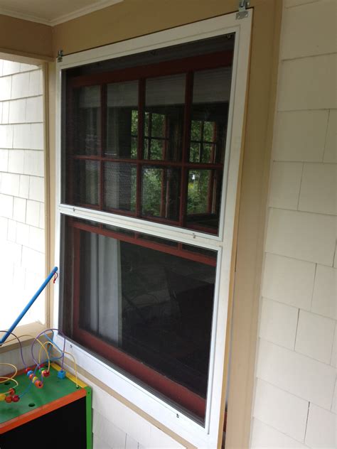 Window with screen. The process for removing a window screen in a slider window is nearly identical to the others. Open the window fully. Find the screen tabs, and push them inward while pulling them toward you. Pop the screen free, and pivot to remove. Set the screen carefully aside until you are ready to replace it. 