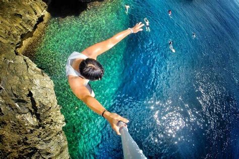 Woman jumping from cliff nude.  Experience breathtaking cliff jumping m...