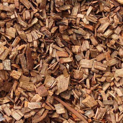 Wood chippings for mulch. Use a rake and gather the wood chips, forming a pile. Position your stack so it receives direct sunlight for at least 6 hours a day. Mix equal proportions of your organic greens. You may use vegetable scraps chopped into small pieces for faster decomposition. Spread a handful of fertilizer evenly on your pile. 