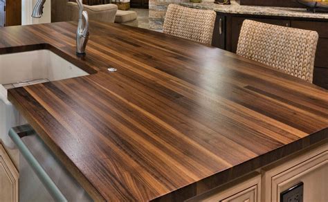 Wood countertops kitchen. Although butcher block wood is common, wide wood planks and natural live edge wood counters have become popular. It is easy to understand why, with their rich ... 
