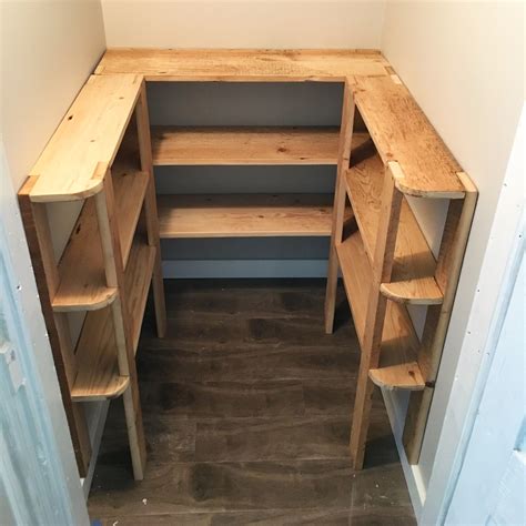 Wood pantry shelving. Cut for each shelf a 2x4 in the desired shelf length. Then cut supports in the desired shelf depth minus 1-1/2". You'll need a support on each end, and then center supports about every 3-4 feet. For heavier loads, keep spans about 3' max. Then build the shelf supports first on a flat level surface, using the longer screws. 