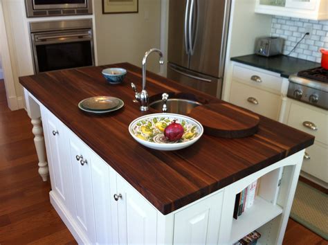 Wooden kitchen countertops. 05 May 2022 ... Wood counter tops mimic the rich hardwood floor in this light and airy kitchen. Pops of color add a touch of fun! 