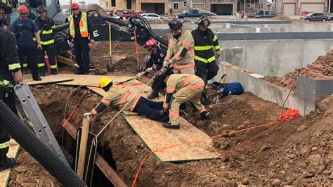 Worker rescued from trench after scaffolding collapses at suburban construction site