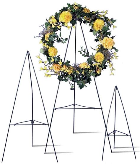Sturdy ground stone wreath stand/hanger measures 21 inches from the ground. The stake at the base of the stand inserts easily in the ground and is constructed of brushed stainless steel which will not rust or corrode from the elements. The design extends over the ground stone which makes lawn care easy. cemetery wreath stand.. 