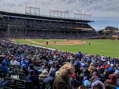 Wrigley Field. Chicago Cubs vs Miami Marlins. Great seats. Can see everything. But you're right behind the camera well. So there might be camera guys blocking some of your view. But behind the camera well is technical "first row". So you get a railing and can lean forward like a first row section. 324R.. 