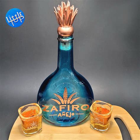 Zafiro añejo tequila. Memorabilia ideas. (NOT A Jenny Lind Calabash to be clear)-Tequila bottle is approximately 9tall 12 with cork. Bottle is an antique WHEATON NJ Embossed Blue Glass Bottle Glassboro 1850. Zafiro Añejo logo is only painted on as to not ruin the original antique bottle (show piece, handle with care, can not be scrubbed) 