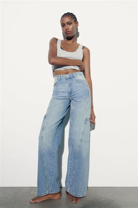 MID-RISE - FULL LENGTH Mid-rise jeans with five pockets. Faded effect. Wide-leg design with displaced seams. Front zip fly and metal button fastening.. 