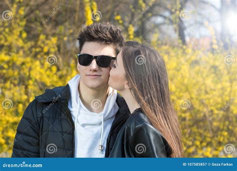 a girl kissing a boy on cheek