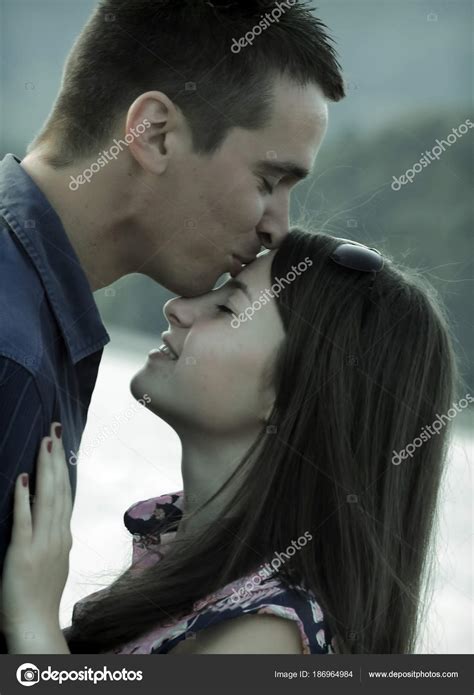 boy kissing a girl on her forehead picture