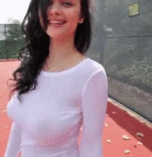 woman taking off bra unedited gif