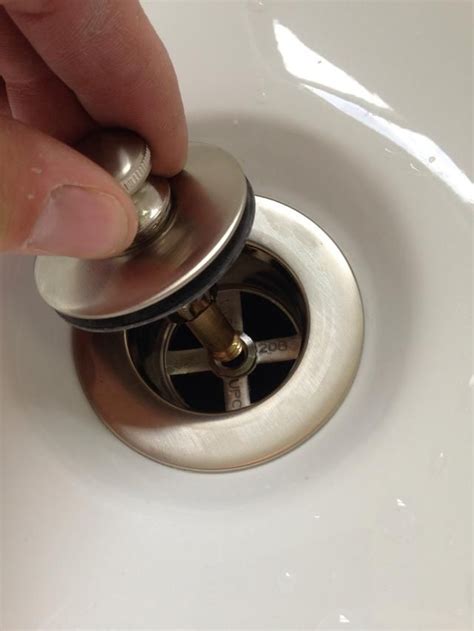 How To Remove Drain Spout From Bathroom Sink?