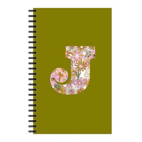 Pink lined notebook with initial J in a wreath