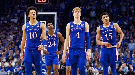 Mar 30, 2023 · A Kansas fan holds a sign in sup