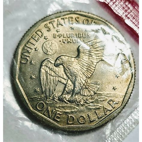 A Morgan dollar coin atop a one-dollar silver c