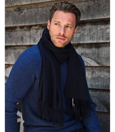 man with a blue scarf on sitting for a portrait b