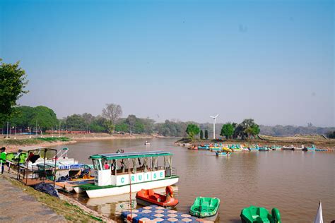 multiple boats on the landmark sukhna lake in chandigarh …