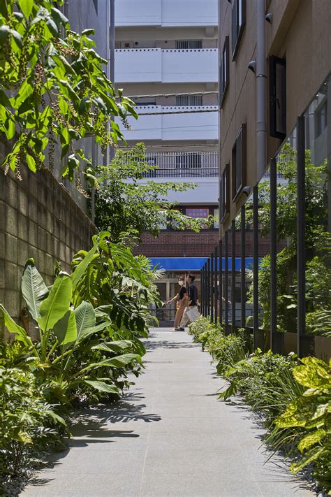 nature-infused path & reflective O_building opens up tokyo street