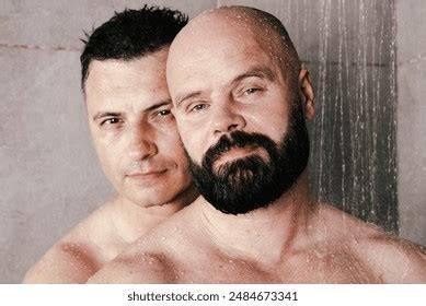 nude men showering together