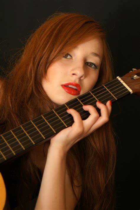 nude playing guitar
