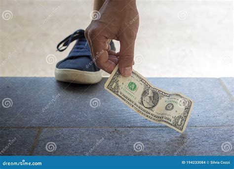 picking up money from ground