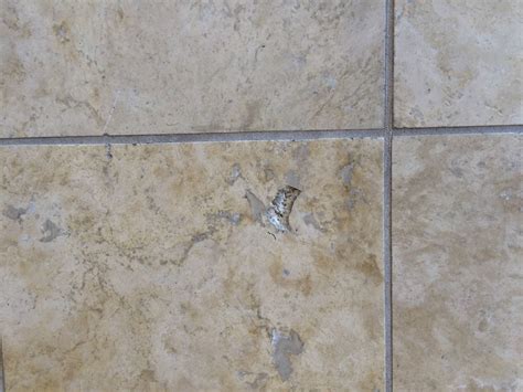 should i fill holes in travertine tile in bathroom?